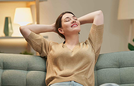 Woman leaning back on couch
