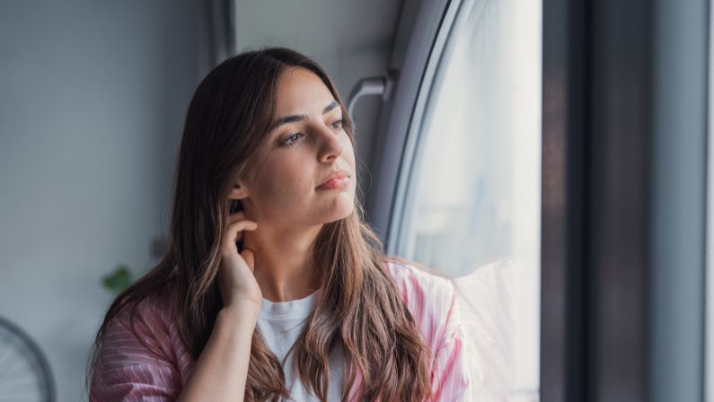 Person sitting quietly at home representing someone managing bipolar disorder and seeking mental health treatment at KAV Mental Health in Ohio